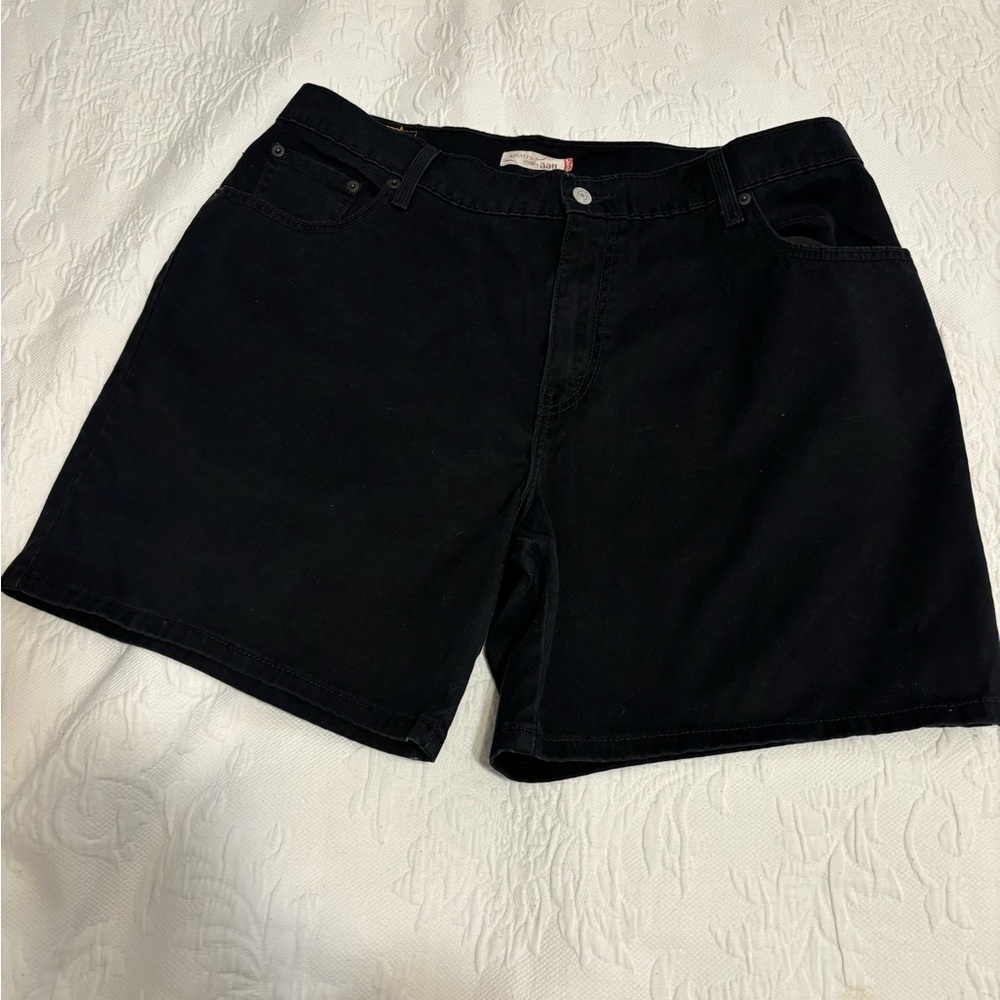 Pair of black Levi’s shorts relaxed fit, casual, cuffed hem with belt loops.